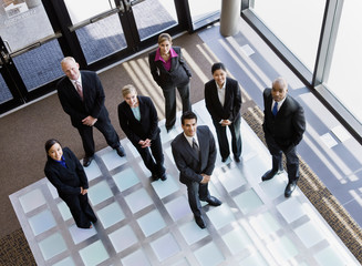 Multi-ethnic co-workers standing in office lobby