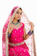 Beautiful Bangali bride in colorful dress and veil, isolated