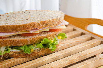 Poster - submarine sandwich with whole grain bread on wood platter