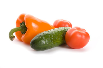 Orange pepper, cucumber and three tomatoes isolated on white