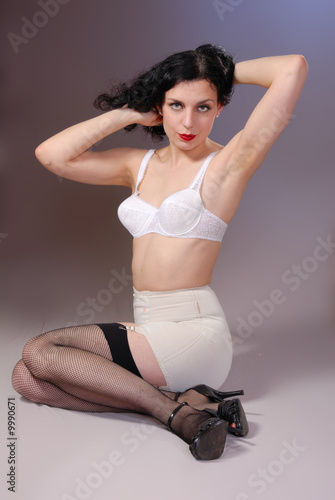 Retro pin-up girl in vintage bra, girdle & fishnet stockings - Buy this  stock photo and explore similar images at Adobe Stock | Adobe Stock