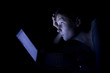 Young woman with laptop at night.