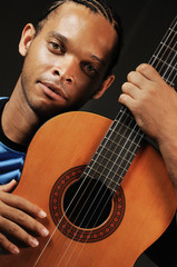 Wall Mural - young trendy african american man with acoustic guitar