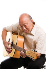 Poster - An isolated shot of a senior asian man playing guitar