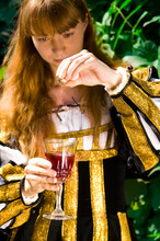 Crafty Young Woman In Renaissance Dress Poisoning Wine