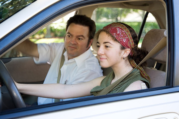 Teen learning to drive or taking driving test.