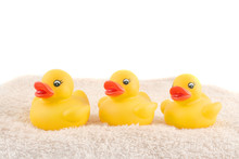 Three Child's Rubber Duck On Top Of Towel Ready For Bath Time