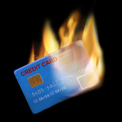 Bank credit card in flames on black background.