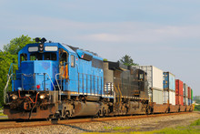 Two Locomotives Pulling A Train Of Container Cars