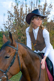 Fototapeta Konie - Pretty young woman riding beautiful horse.