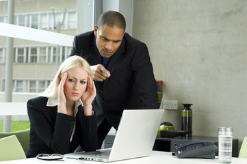 business man giving a female work college a hard time