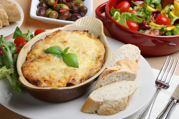 Canvas Print - Lasagna with Italian salad and crusty bread