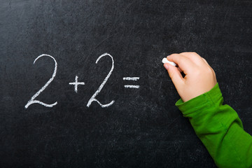 Simple math formula written on chalkboard