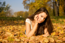 Young Beautiful Woman Lying In The Autumn Park
