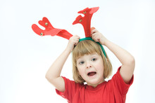 Little Girl Wearing Reindeer Horn Headband, On White