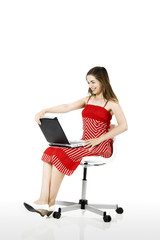 Poster - Portrait of a woman seated on a chair with a laptop