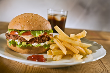 cheeseburger french rries and coke on a plate