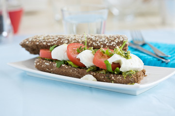 Poster - Delicious mozarella tomato sandwich on a small plate