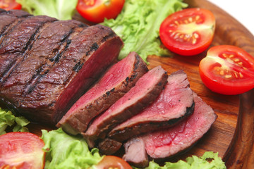 grilled red beef meat on wooden plate