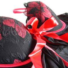 The top of black lingerie with red strings closeup