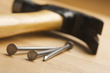 Hammer and Nails Abstract on Wood Background.