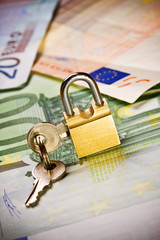 euro banknotes money with padlock and key