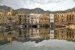girne harbor with boats and houses and reflection
