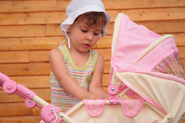 Wall Mural - Girl with children's carriage