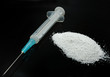 narcomania concept - heroin,syringe againt black