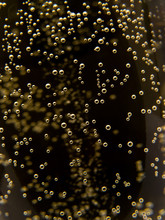 Macro Of Sparkling Champagne Against Black Background.