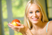 Portrait Of Young Happy Smiling Woman With Apple