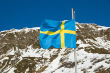 Swedish Flag Is Waving In The Mountain Wind