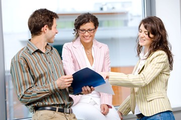 Poster - Happy young business people having team meeting at office