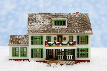 Wall Mural - House with Christmas decorations on snow with snowflake