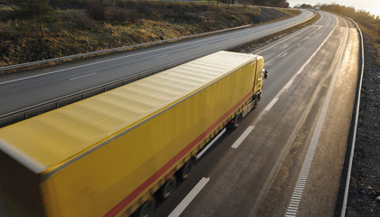 Poster - yellow truck speeding into sunset