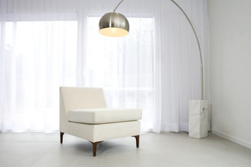 Contemporary interior with lamp and chair