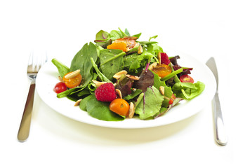 Wall Mural - Plate of green salad on white background