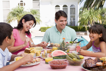 Family Enjoying A Barbeque