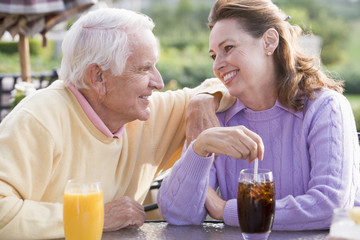 Couple Enjoying A Beverage By A Golf Course