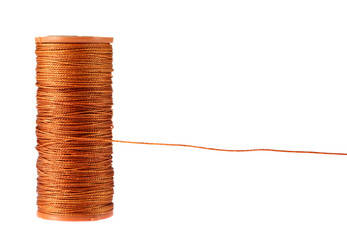 Close-up of the orange strong thread spool isolated on white