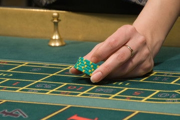 casino dealer handling gambling chips