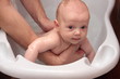 © endostock - Two months white  baby girl taking bath