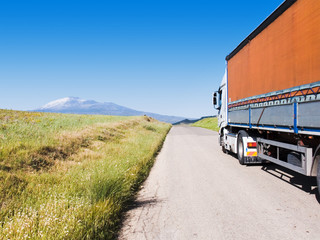 landscape for truck on road, background volcano Etna