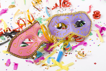 carnival masks and colorful confetti on white