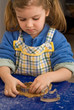 Cute little girl baking gingerbread cookies