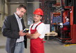 © endostock - boss talking to worker in uniform in factory
