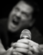 Male Heavy Metal Singer Screams into Microphone