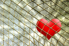 Red Heart In Rope Net Against Wall