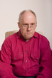 © dbvirago - Old Guy in Red Shirt Looking Thoughtful