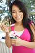 © Stephen Coburn - Pretty Asian Woman Eating Yogurt